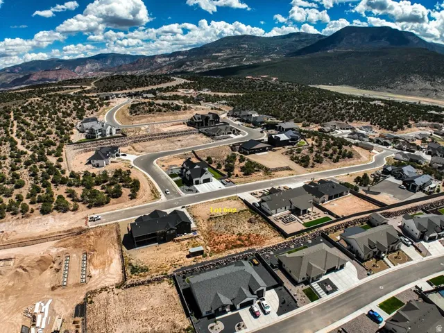 Aerial perspective of a developing residential area with paved streets and established homes