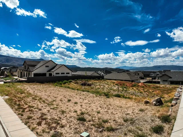 Expansive vacant lot with distant mountain and water scenery