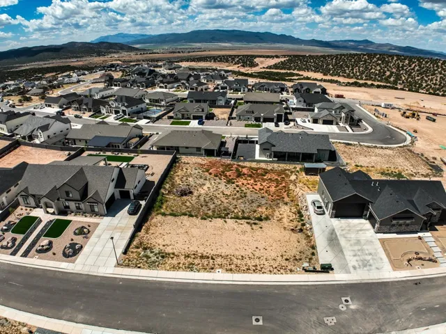 Expansive vacant lot, situated within a developing residential area, offering a clear building site