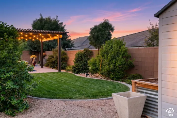 Backyard: Curved lawn and landscaped beds edged in concrete curbing