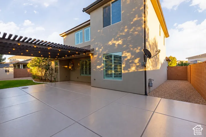 Back Exterior: Wide concrete patio across the back of the home