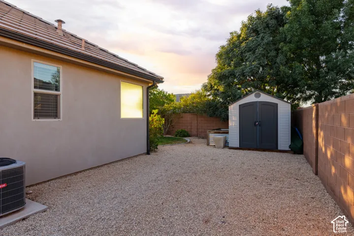 Side Yard: Storage shed tucked into the gravel side yard