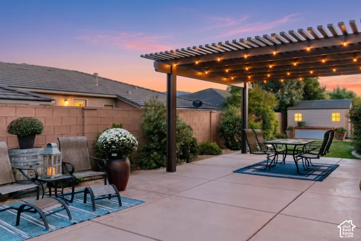 Patio: Twilight on the extended concrete patio under a string-lit pergola