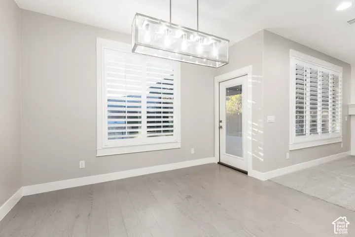 Dining Room: Shown vacant, with plantation shutters and a door to the covered patio