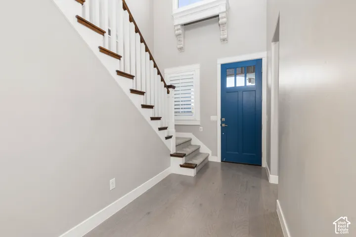 Foyer: A wood stair railing and the blue front door greet you at the entry
