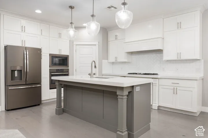 Kitchen: Built-in microwave and wall oven, a French-door refrigerator, and floor-to-ceiling cabinetry