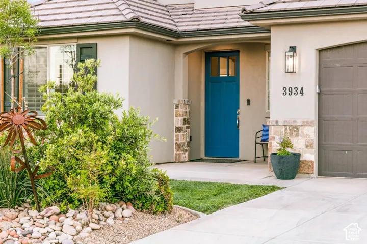 Entry: A blue front door framed by desert landscaping