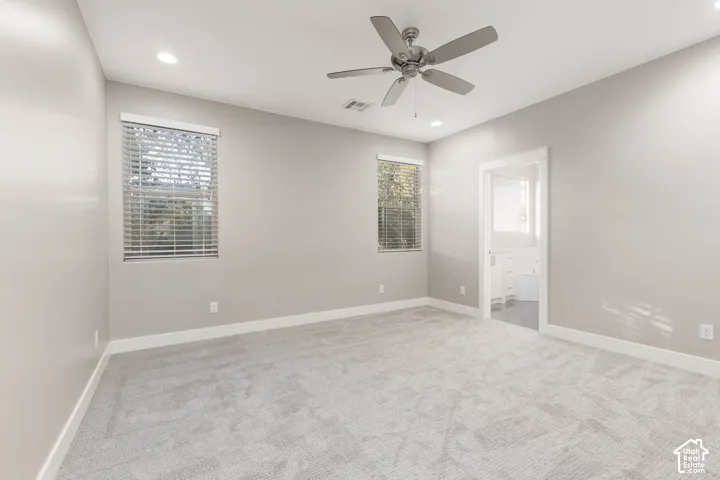 Primary Bedroom: Shown vacant, with new carpet and a door to the ensuite bath