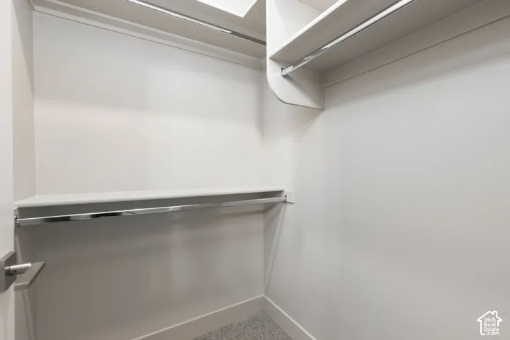 Bedroom: Walk-in closet with built-in shelving and hanging rods