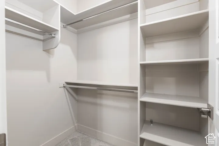 Bedroom: Walk-in closet with built-in shelving off the main-floor bedroom