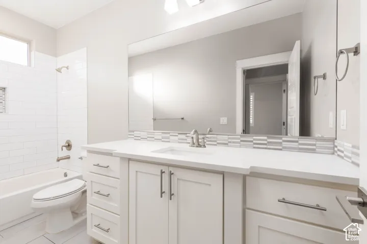 Bathroom: Main-floor full bath with a tub-shower combination and quartz vanity