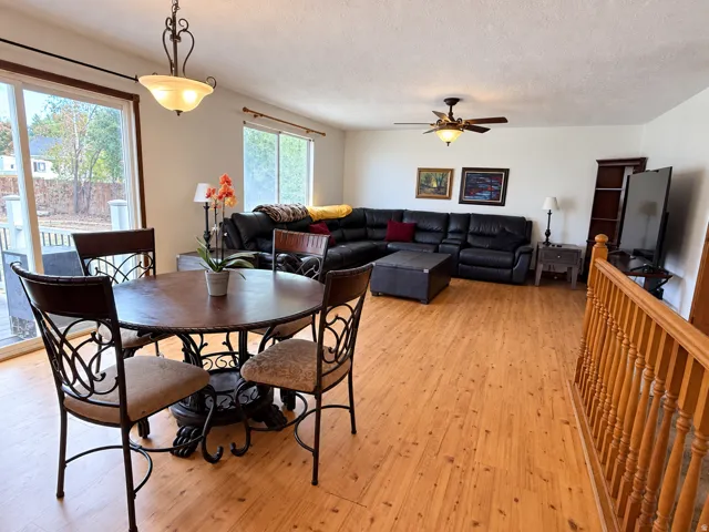 Wood-finish flooring throughout, with a ceiling fan and recessed lighting