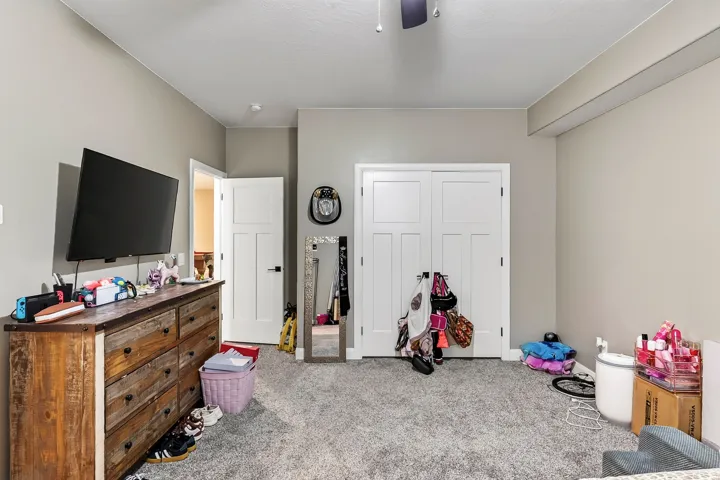 Recessed ceiling lighting with a ceiling fan, light gray wall paint, white interior doors, and gray carpet flooring