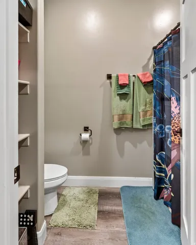 Built-in shelving, wood-finish flooring, and white baseboards