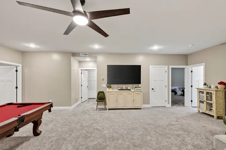 Recessed lighting, ceiling fan with integrated light, light gray carpeting, and white paneled doors