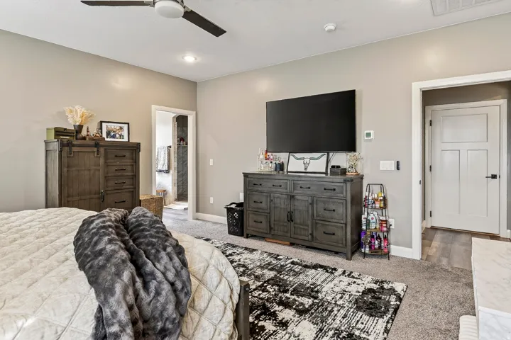 Recessed lighting, ceiling fan, carpeted flooring, and a white interior door with black hardware