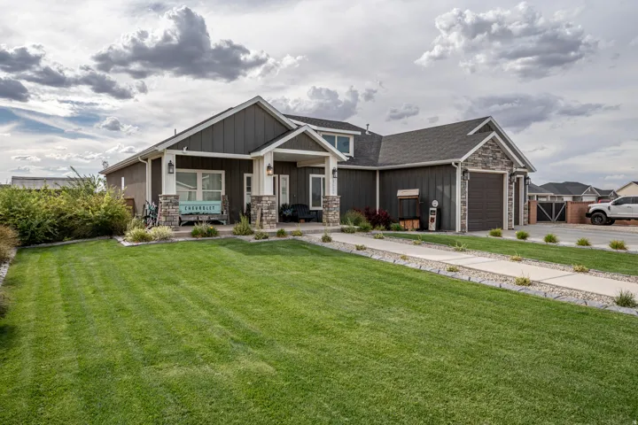 Contemporary ranch-style residence showcasing a clean architectural design with mixed exterior finishes including stone accents and dark siding