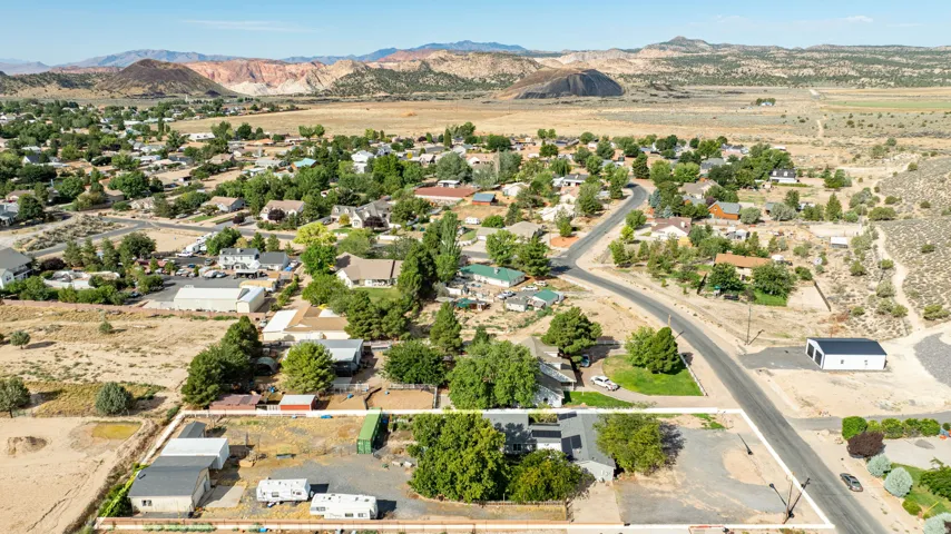 Aerial view showcasing this property nestled within an established residential community, surrounded by mature landscaping and tree-lined streets