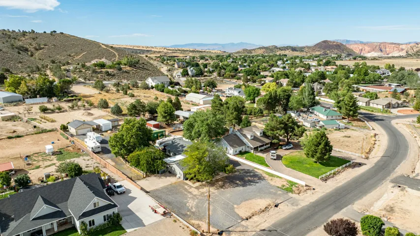 Aerial view showcasing this residential property nestled within a tree-lined community