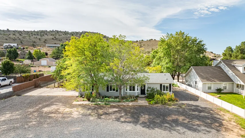 Charming single-story residence set on expansive grounds with mature shade trees and manicured landscaping