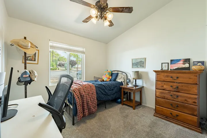 Bright bedroom with ceiling fan and recessed lighting, carpeted flooring, and glass sliding doors opening to outdoor space