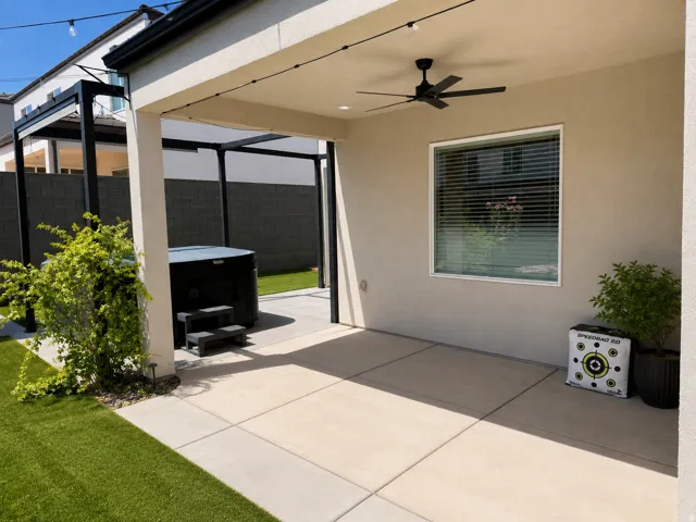 Covered patio featuring a ceiling fan, string lighting, and direct access to a hot tub under an open-air pergola