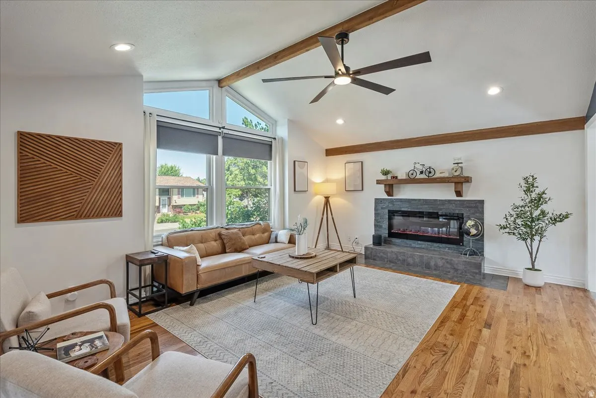 Vaulted ceiling with exposed wood beams and recessed lighting