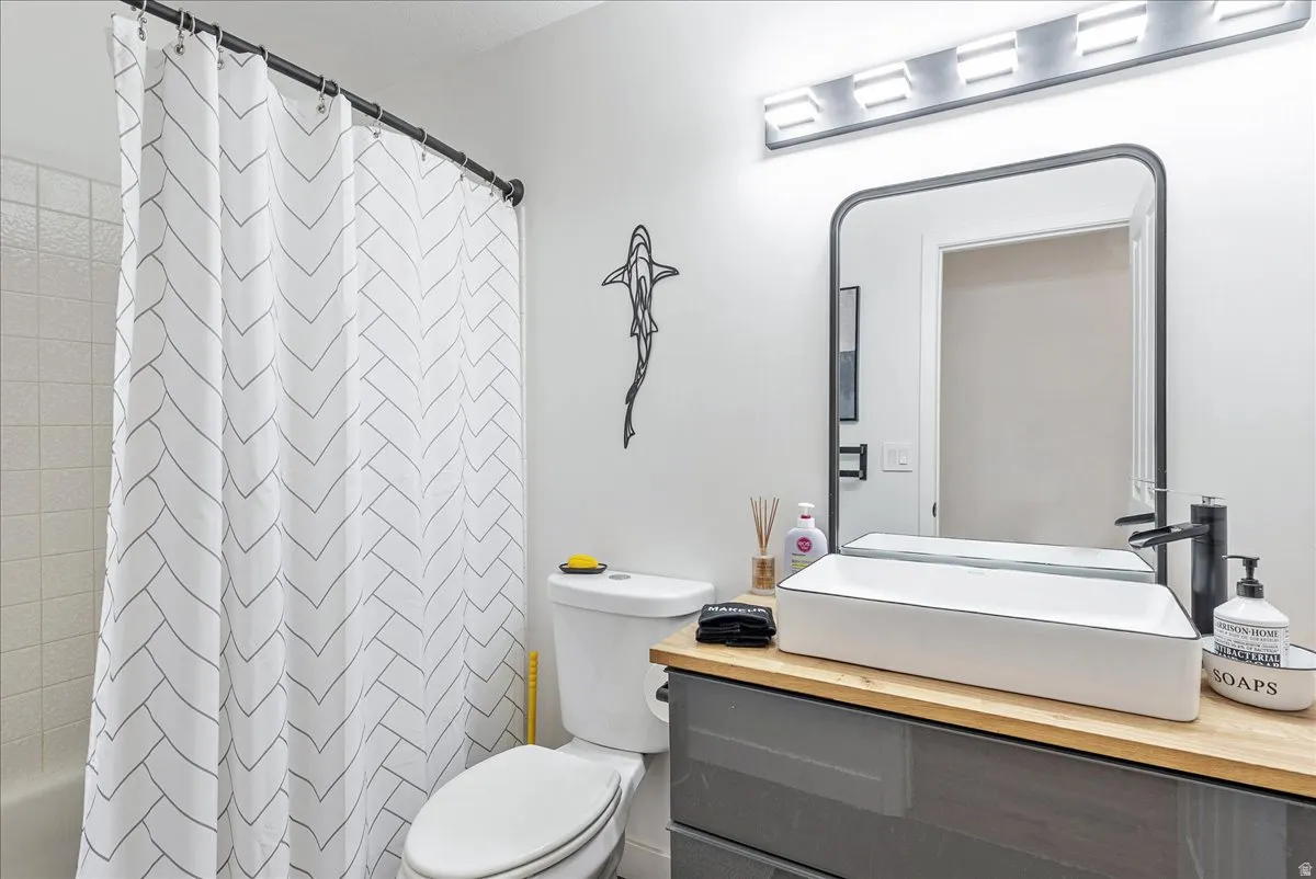 White tiled bath and shower combination