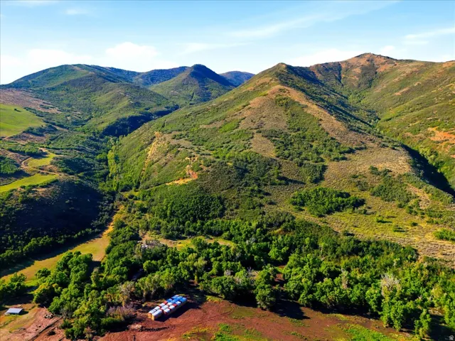 Expansive mountainous terrain featuring diverse vegetation and significant elevation changes