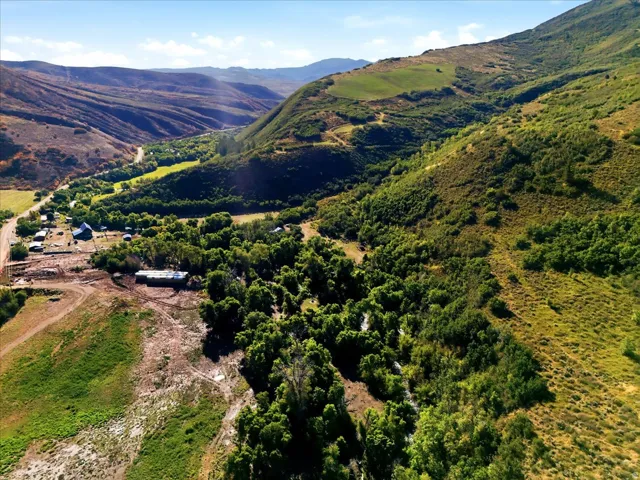 Expansive acreage surrounded by natural landscape and distant mountains