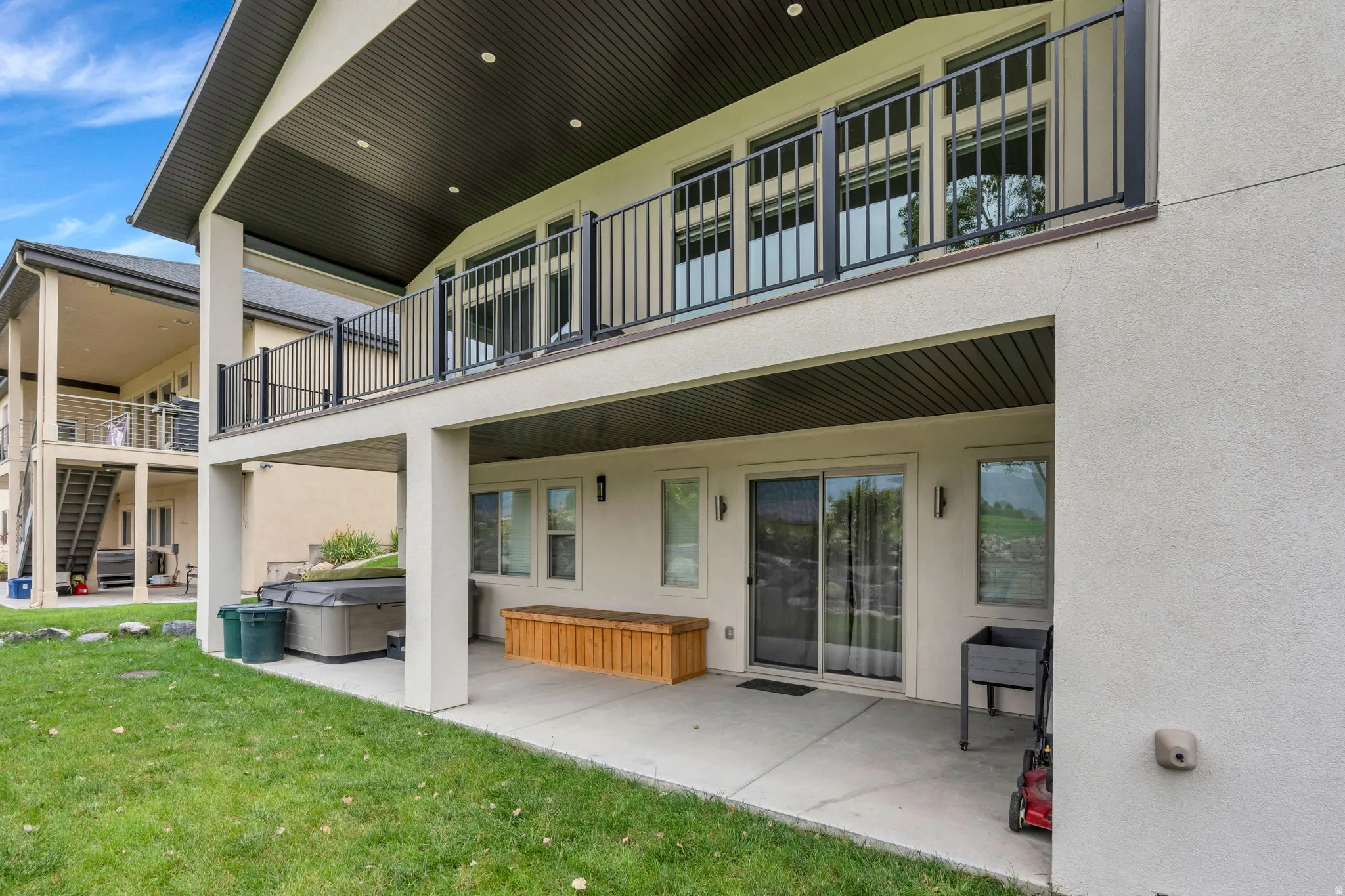 Lower level patio with concrete flooring, covered ceiling, and sliding glass door access