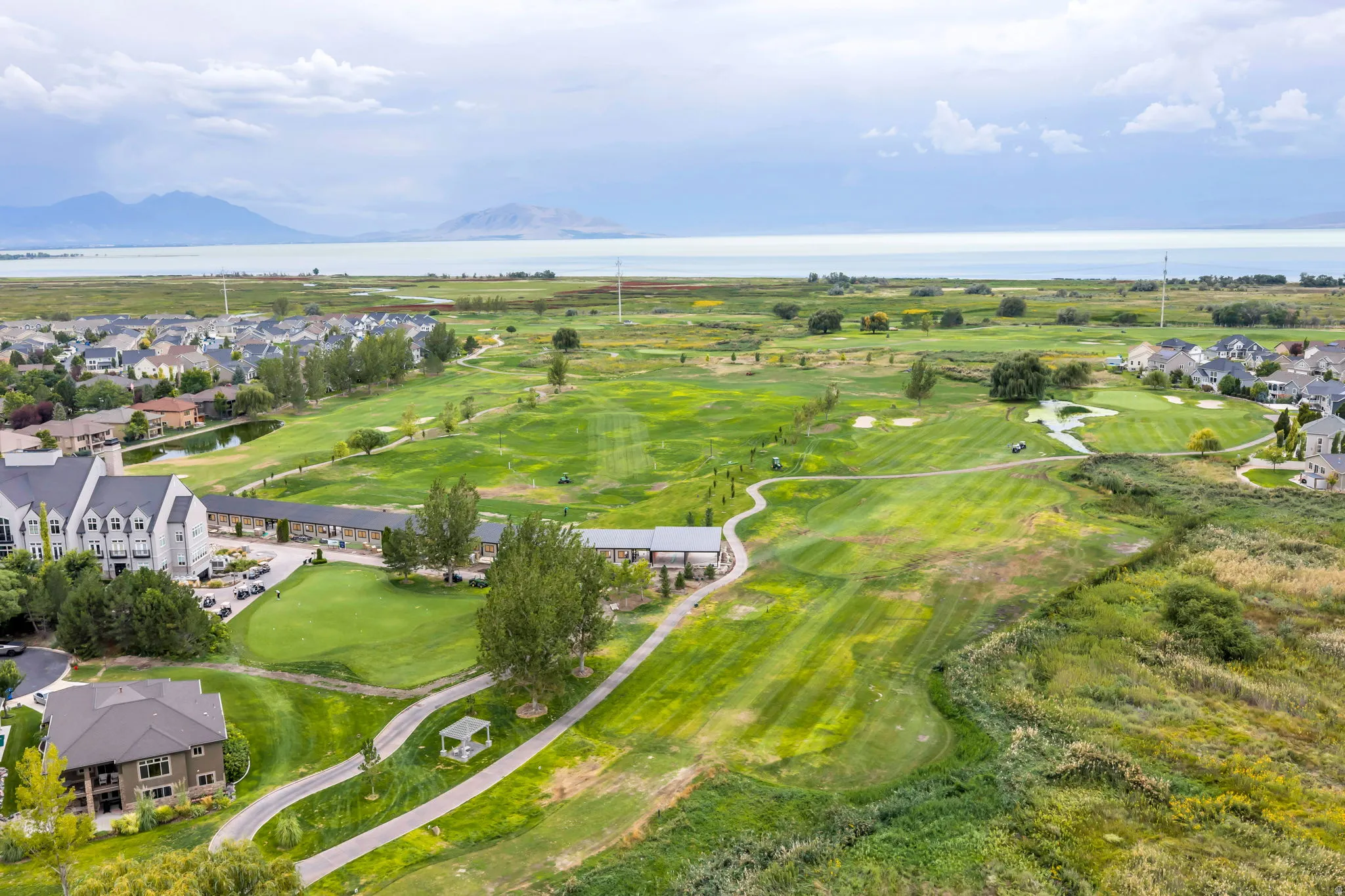 Expansive golf course setting with manicured greens and surrounding residential properties