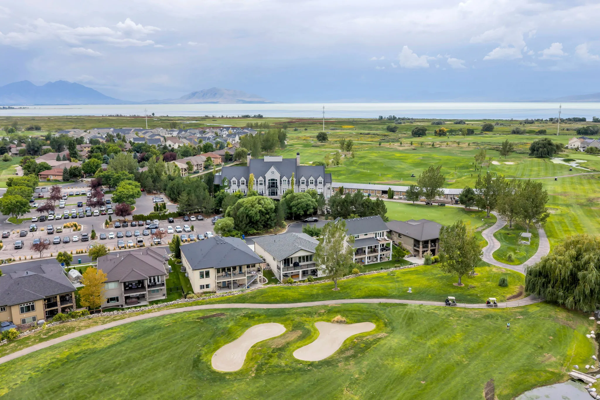 Lush golf course setting with sand traps and golf carts