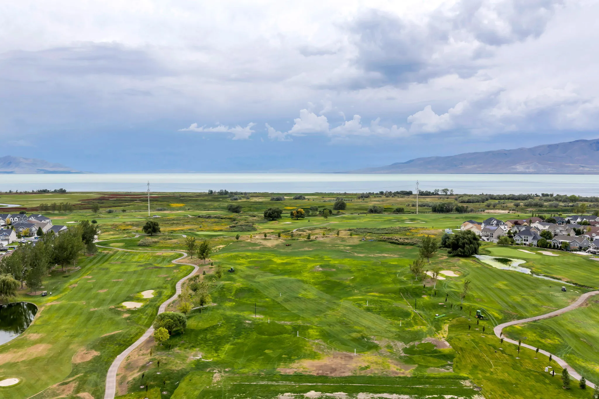 Expansive golf course setting featuring manicured greens and winding pathways