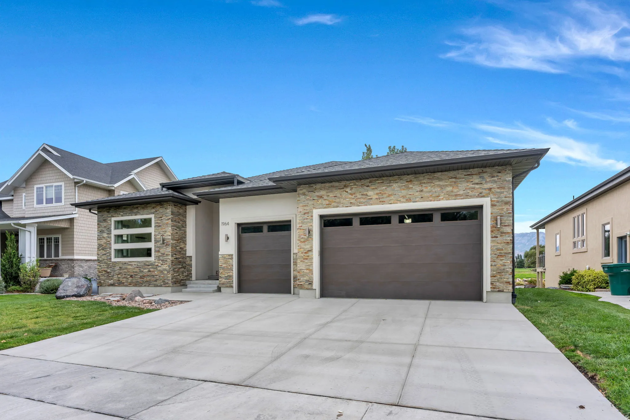 Contemporary single-story residence with stone and stucco exterior