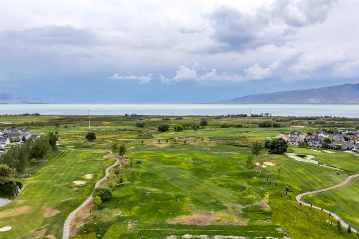 Expansive golf course setting featuring manicured greens and winding pathways
