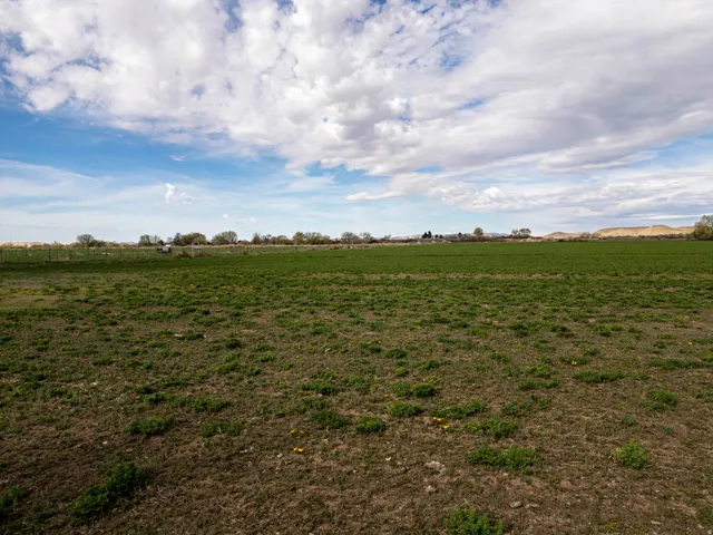 Expansive land featuring a large, cultivated field
