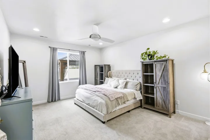 Primary bedroom, recessed lighting, ceiling fan, carpeting, and a window with a white frame