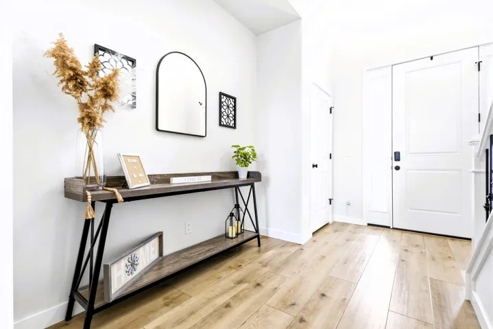White interior doors, light wood-finish flooring, and white baseboards
