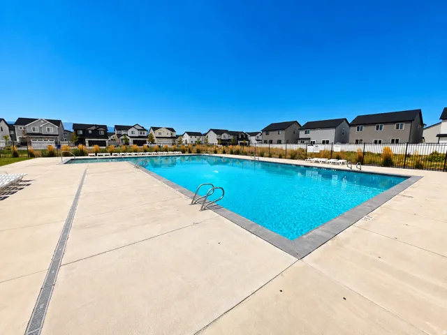 Community outdoor swimming pool with concrete decking