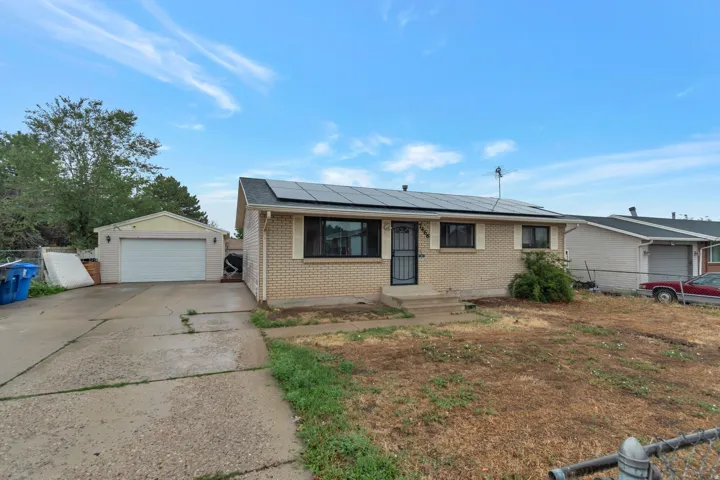 Brick exterior, solar panels, attached garage, detached garage, concrete driveway