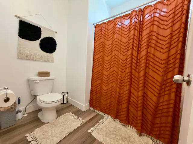 Primary bathroom with toilet & shower in separate room