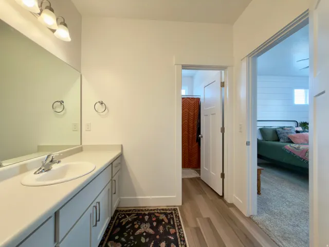 Primary bathroom with large counter space & storage cabinets. Shower & toilet in separate room