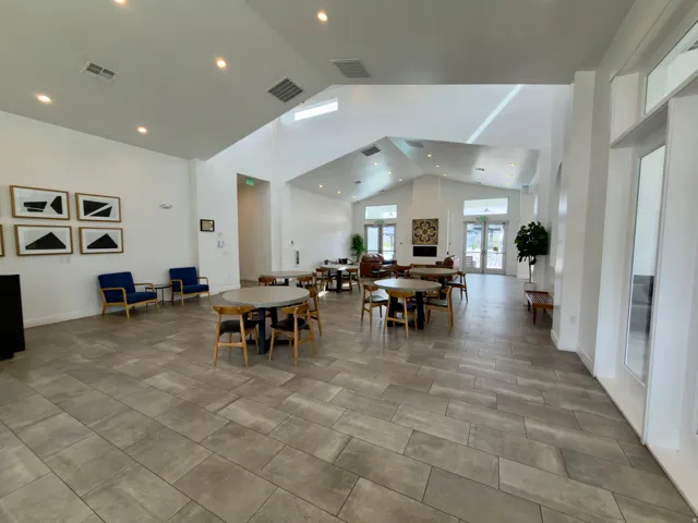 Clubhouse vaulted ceilings, skylights, recessed lighting, and rectangular tile flooring