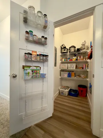Large pantry featuring multi-level wire shelving and LVP flooring
