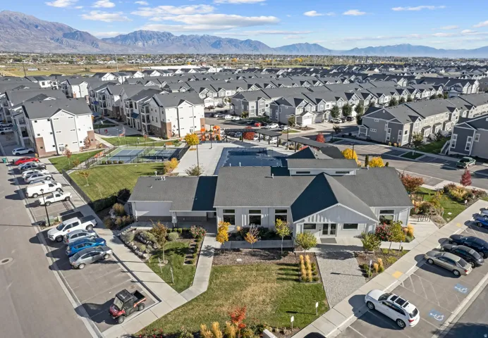 Community clubhouse with a swimming pool, pickleball court, gym, kitchen, gathering area and surrounding landscaping
