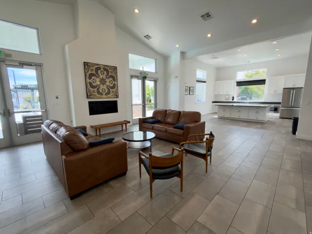 Spacious common area featuring vaulted ceilings, recessed lighting, a built-in fireplace, and tile flooring