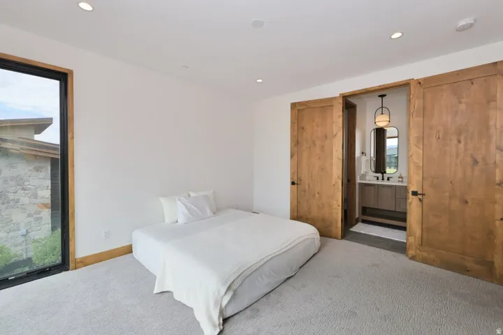 Spacious room with plush carpeting, large picture window, and recessed ceiling lighting