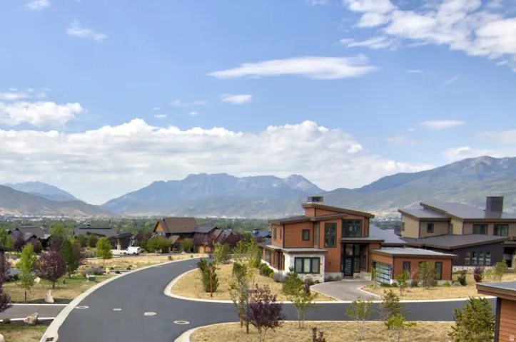 Modern architectural design featuring varied rooflines, wood-panel siding, and stone accents