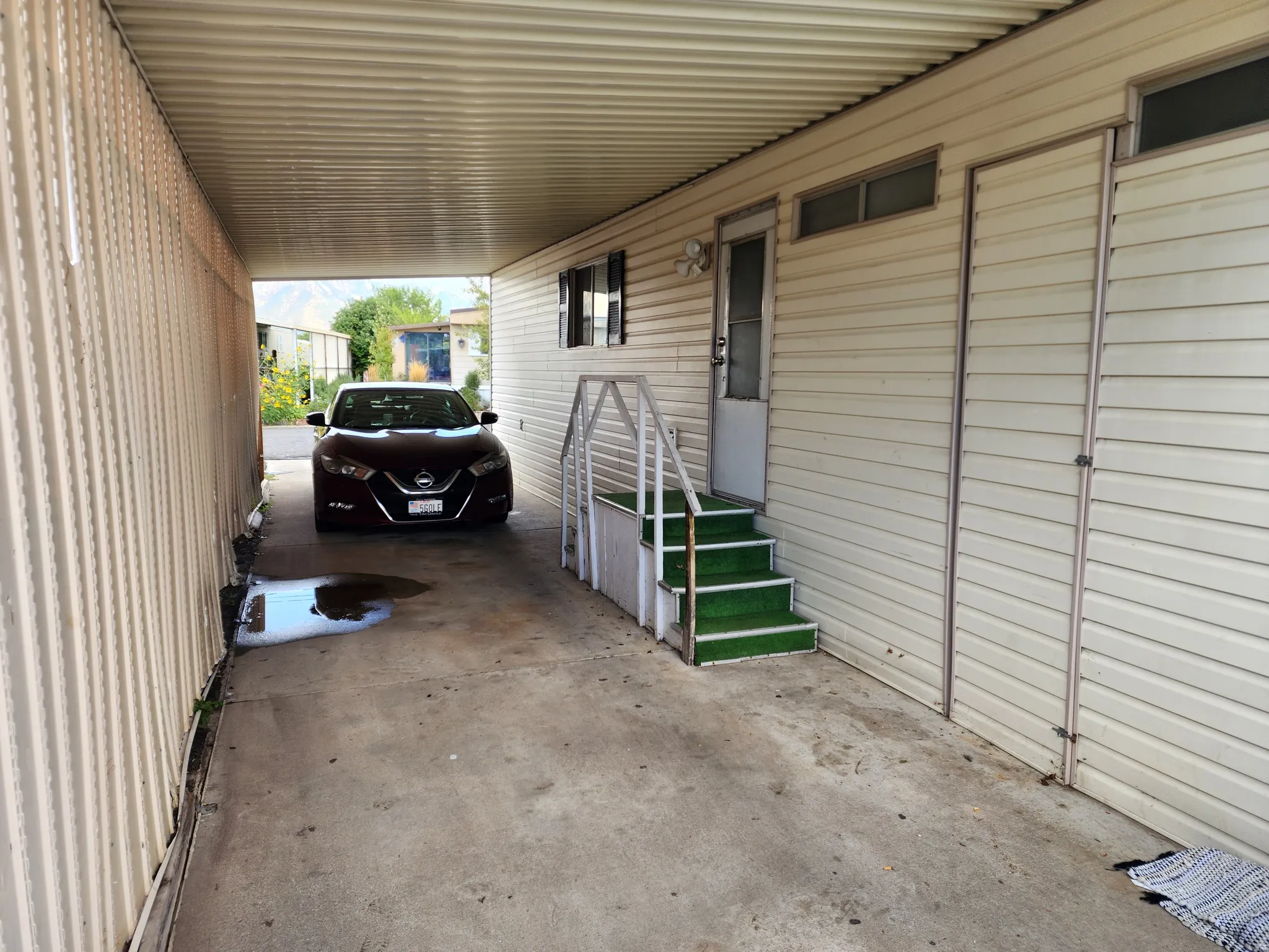 Covered carport with concrete flooring